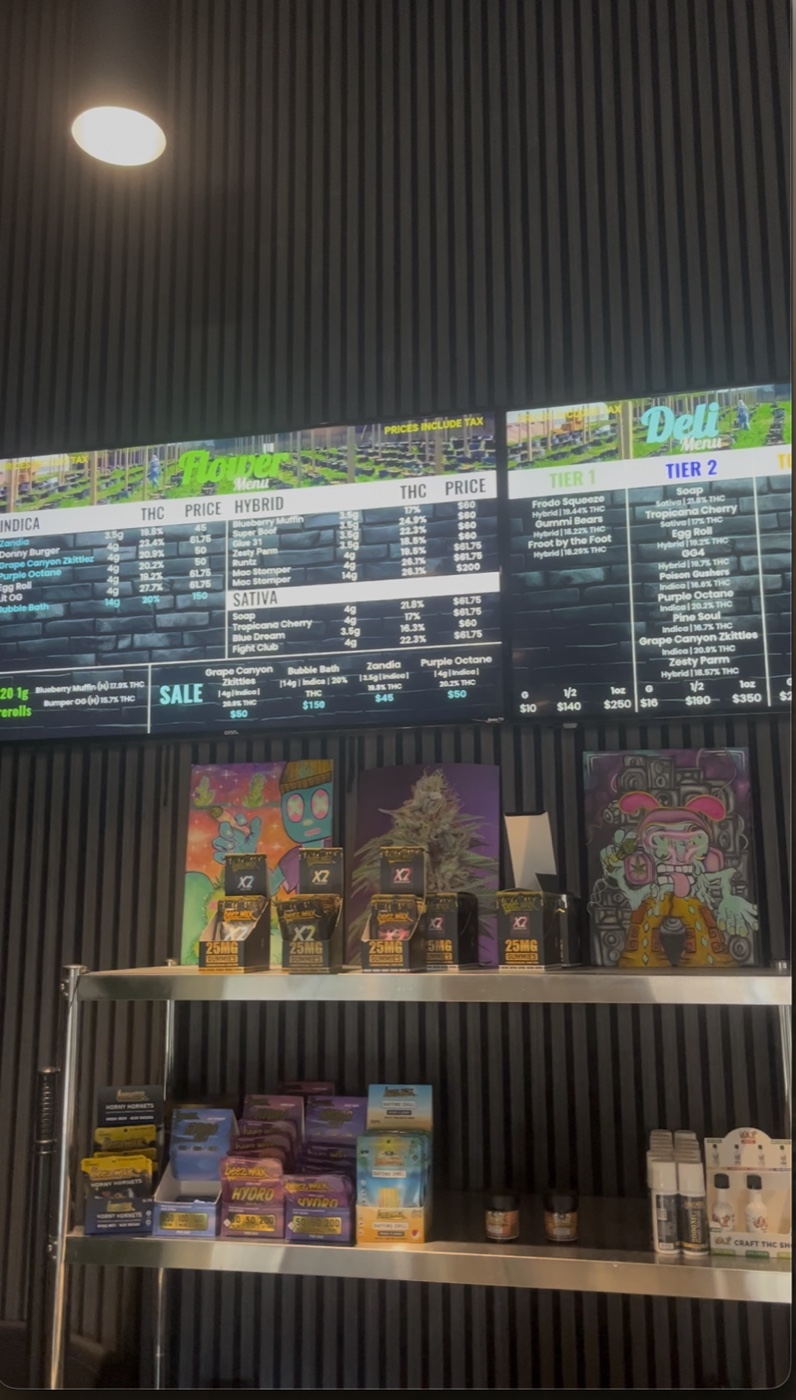 Graffiti character paintings and bud-macro art on stainless shelving inside Hopkins Dispensary.